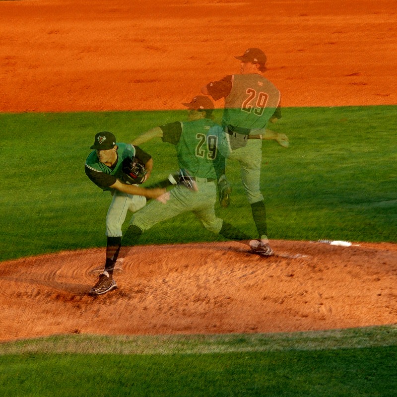 A composite image of a baseball pitcher throwing the ball.  The photo composed of three photos showing the pitcher at different parts of his throw.