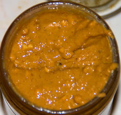 Top surface of a jar of Smucker's Natural Chunky peanut butter after mixing