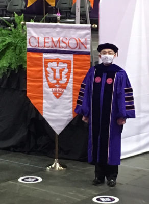 Posing by the Clemson banner